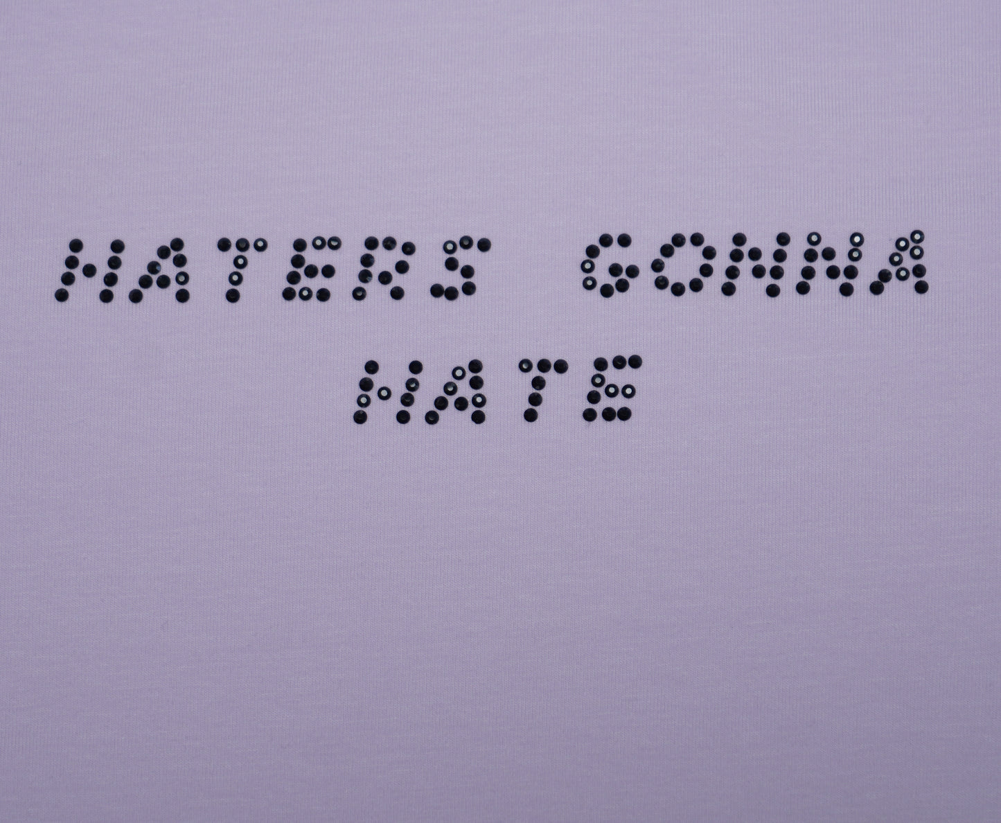 Text made of rhinestones 'HATERS GONNA HATE' on a plain background