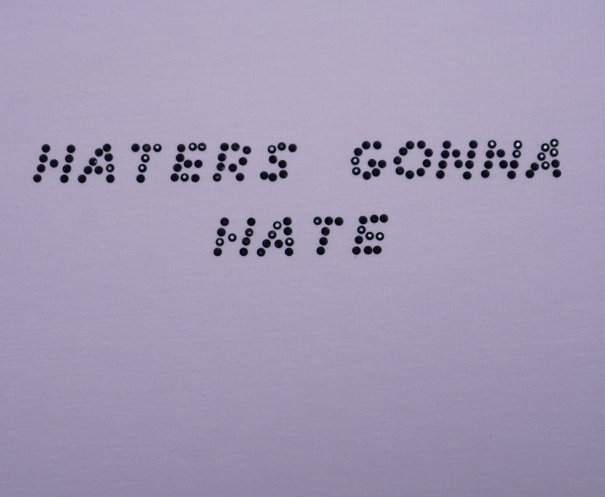 Text made of rhinestones 'HATERS GONNA HATE' on a plain background