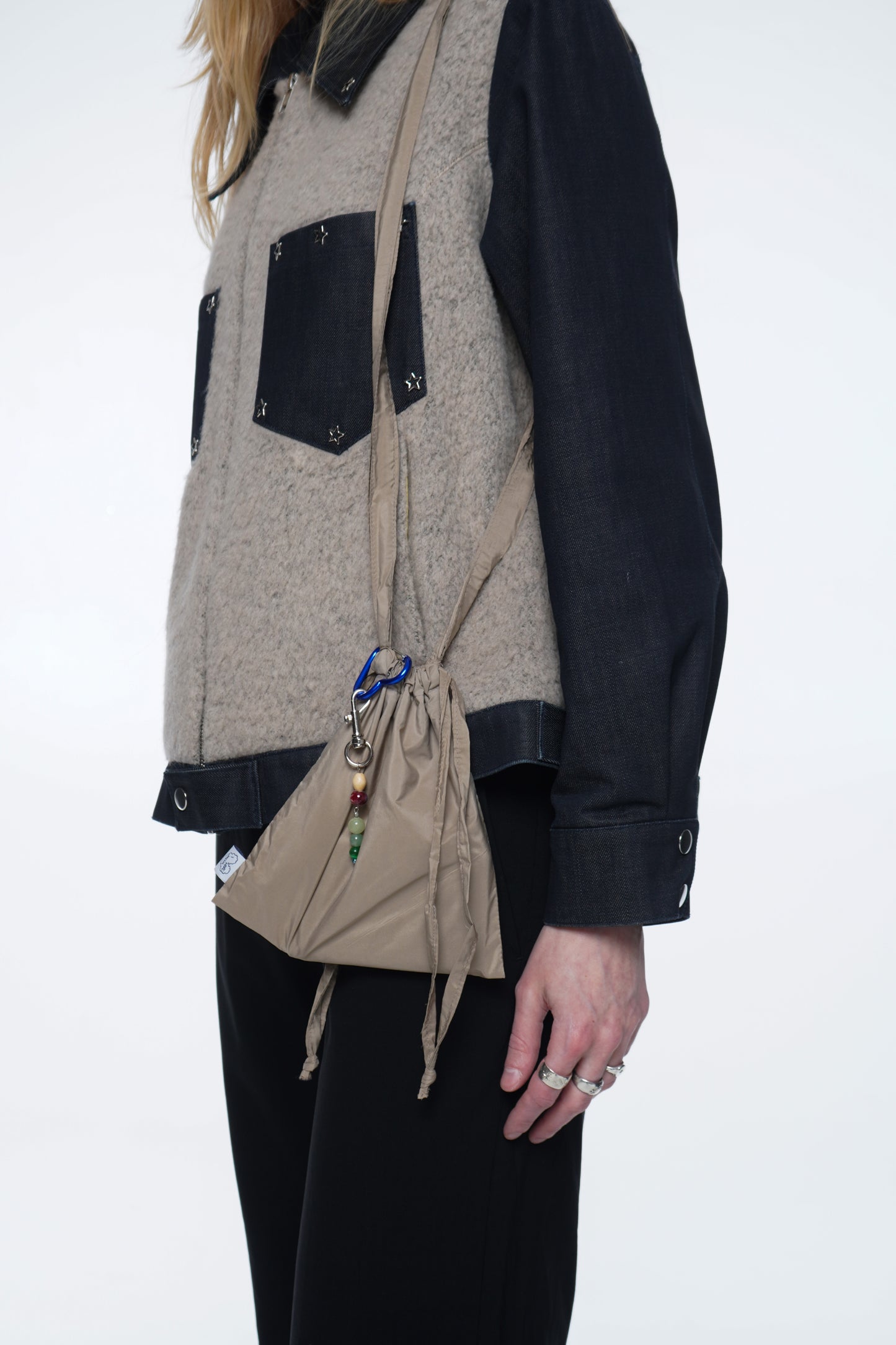 20×20 cm mini bag made from lightweight weather-resistant fabric with a structured shape and full lining.
