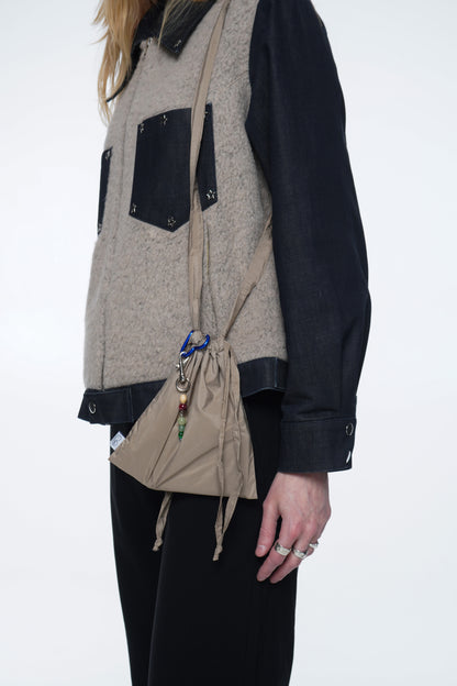 20×20 cm mini bag made from lightweight weather-resistant fabric with a structured shape and full lining.