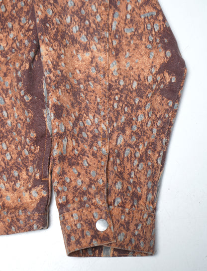 Close-up of a patterned fabric with a button on a white background