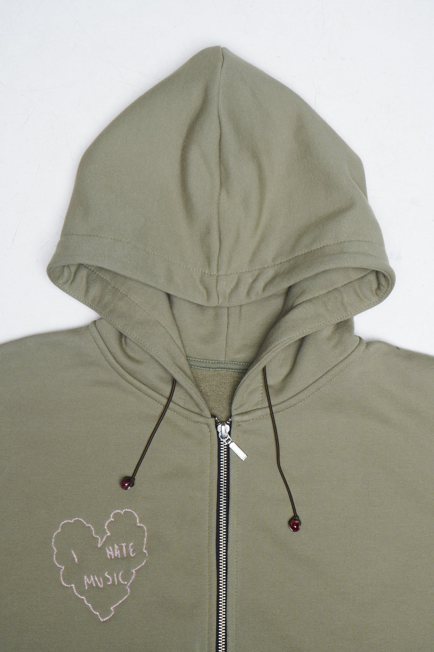 green zip hoodie streetwear, graphic cotton hoodie, unisex fit, minimal design, everyday outfit