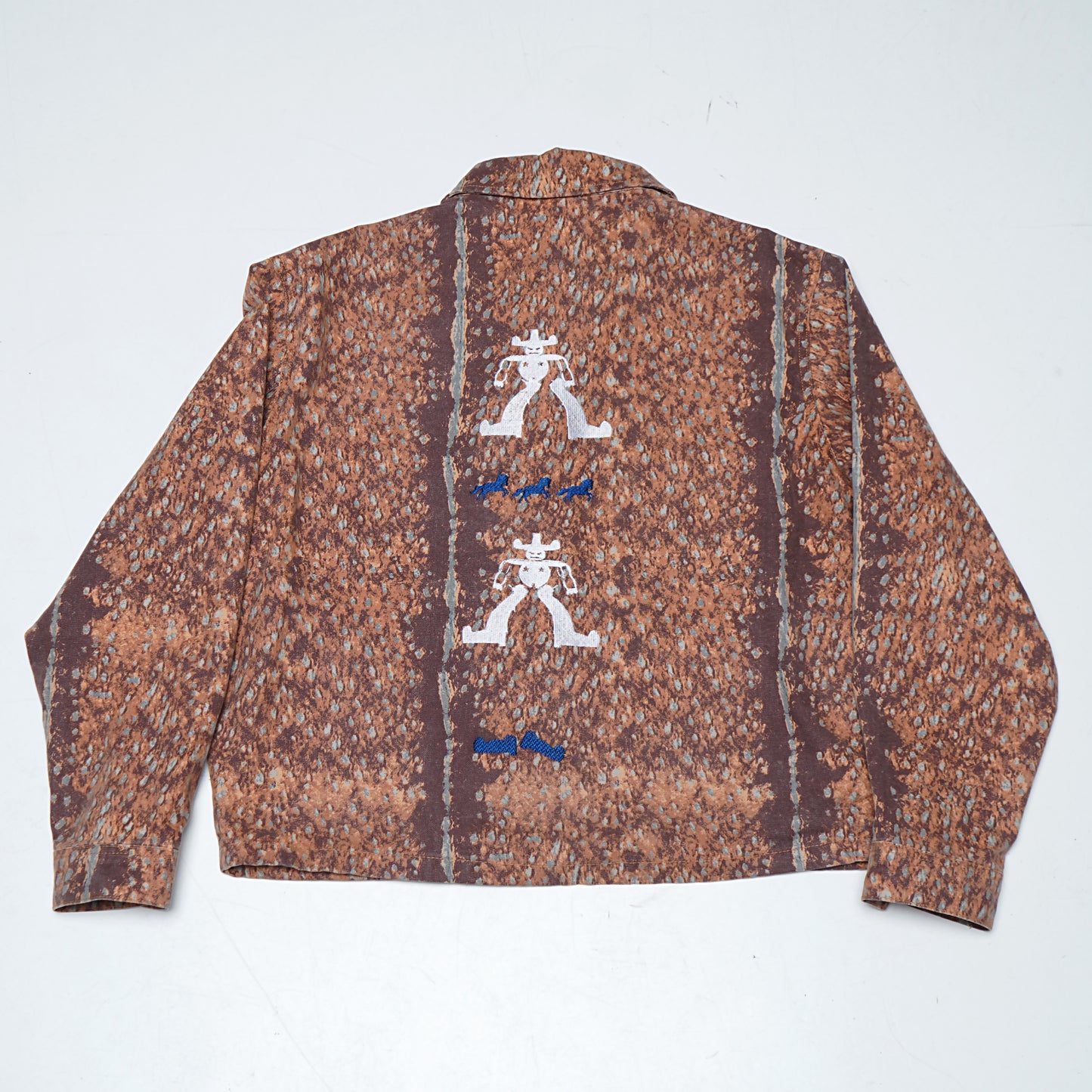 Upcycled jacket transformed with expressive cowboy embroidery and illustration-inspired detailing.